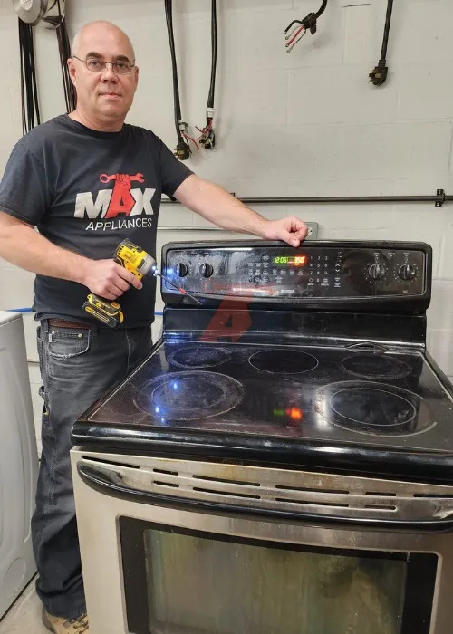 technician performing appliance repair on stove